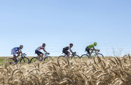 Saint-Quentin-Fallavier,France - July 16, 2016: The breakaway riding in a wheat plain during the stage 14 of Tour de France 2016.のeditorial素材