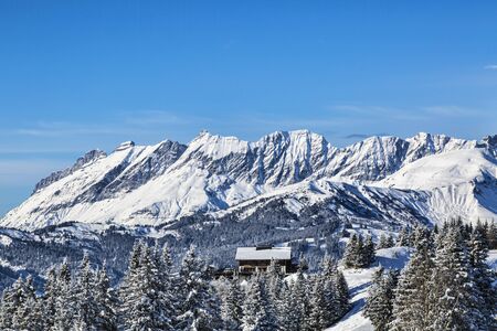 Image of a chalet located at the base of an Alpine peaks chaine close to Mont Blanc Massif.の写真素材