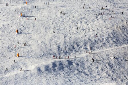 Bird eye view of a ski slope with skiers.
