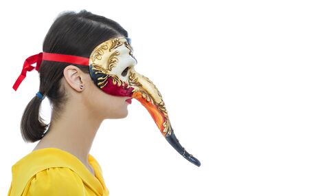 Profile of a young woman with a Long Nose Venetian mask isolated against a white background.の写真素材