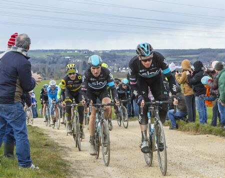 Vendome,France- March 7,2016:The peloton riding on a dirty road,Tertre de la Motte, in Vendome,...