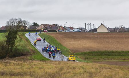Angerville, France - March 6, 2017: The peloton riding on a wet road during the second stage of Paris-Nice on 6 March, 2017.のeditorial素材