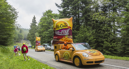 Col de Platzerwasel, France - July 14, 2014: McCain vehicles during the passing of the Publicity Caravan in front of the audience on the road to Mountain Pass Platzerwasel, in Vosges mountains, in the stage 10 of Le Tour de France on July 14 2014. Before のeditorial素材