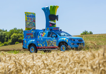 Saint-Quentin-Fallavier, France - July 16, 2016: Haribo vehicle during the passing of Publicity Caravan in a wheat plain in the stage 14 of Tour de France 2016. Haribo is the biggest manufacturer of gummy and jelly sweets in the worldのeditorial素材
