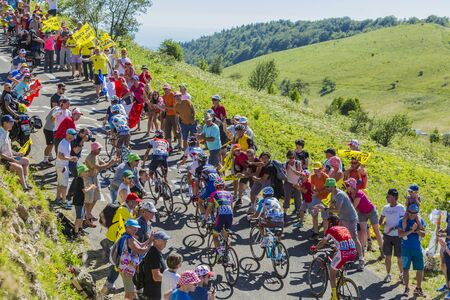 Col du Grand Colombier,France - July 17, 2016: Group of cyclists riding in a hairpin curve at Col du Grand Colombier in Jura Mountains during the stage 15 of Tour de France 2016.のeditorial素材
