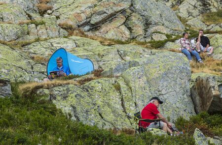 Col de la Croix de Fer, France - 25 July 2015: Spectators on rocks waiting for the peloton near the road to the Col de la Croix de Fer in Alps during the stage 20 of Le Tour de France 2015.のeditorial素材