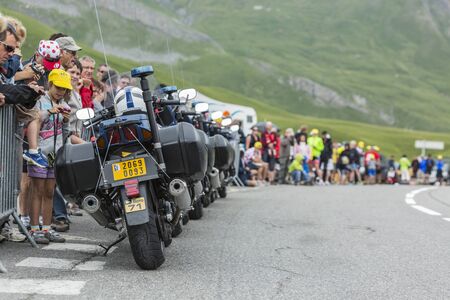 Col du Lautaret, France - July 19, 2014: Row of empty police bikes in front of the spectators on the side of the road on Col du Lautaret in Alps during the stage 14 of Le Tour de France 2014.のeditorial素材