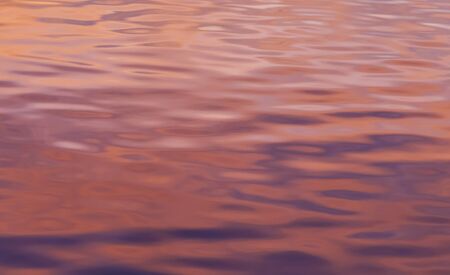 Abstract image of sunset colors reflected in a pond.