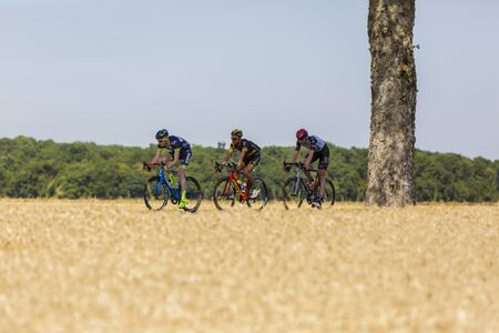 Vendeuvre-sur-Barse, France - 6 July, 2017: Three cyclists (Backaert of Wanty-Groupe Gobert Team, Quemeneur of Direct Energie Team, Laengen of UAE Team Emirates) in the breakaway pass through a region of wheat fields during the stage 6 of Tour de France 2のeditorial素材