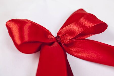Close-up of a the node of a red festive bow. Shallow depth of field.の写真素材