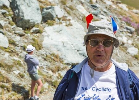 Pass of the Iron Cross, France - July 25, 2015: Environmental portrait of an unidentified fan on the road to the Cross of Iron Cross in Alps during the stage 20 of The Tour de France 2015.のeditorial素材