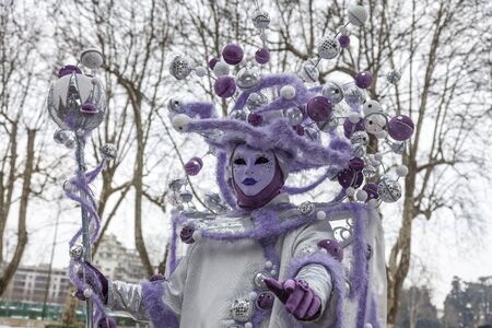 Annecy, France, February 23, 2013: Portrait of a disguised person posing in Annecy, France, during a Venetian Carnival which celebrates the beauty of the real Venice.のeditorial素材