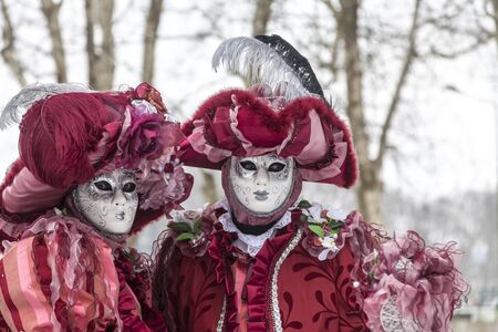 Annecy, France, February 23, 2013: Portrait of a disguised couple posing in Annecy, France, during a Venetian Carnival which celebrates the beauty of the real Venice.のeditorial素材