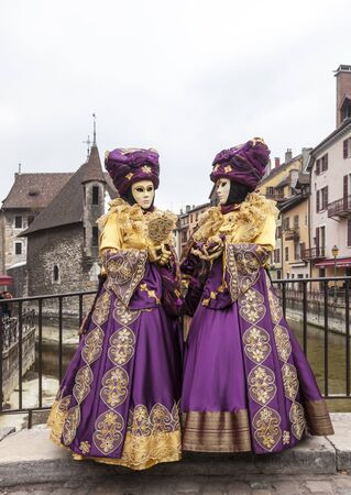 Annecy, France, February 23, 2013: A disguised couple posing in Annecy, France, during a Venetian Carnival which celebrates the beauty of the real Venice.のeditorial素材