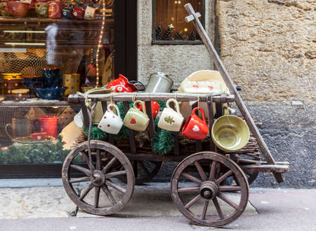Annecy, France, February 23, 2013: Traditional street decoration with a wooden cart and dishes in Annecy, France, during a Venetian Carnival which celebrates the beauty of the real Venice.のeditorial素材