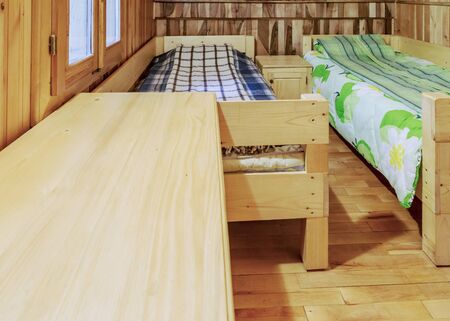 Bedroom with two beds in a wooden chalet.の写真素材
