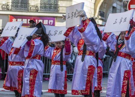 Paris,France-February 25,2018: Environmental portrait of an unidentified Chinese little girl during the 2018 Chinese New Year parade in Paris.のeditorial素材