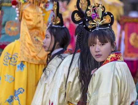 Paris,France-February 25,2018: Environmental portrait of an unidentified Chinese girl looking back during the 2018 Chinese New year parade in Paris.のeditorial素材