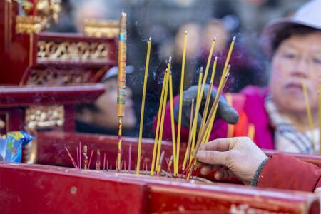 Paris, France-February 25,2018: Detail of Buddhist prayer sticks burning on a mobile shrine during the 2018 Chinese New year parade in Paris.のeditorial素材