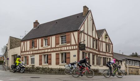 Dampierre-en-Yvelines, France - March 4, 2018: The breakaway (Pierre Rolland, Jurgen Roelandts,Pierre-Luc Perichon) passing in front of a traditional half timbered house during the stage1 of Paris-Nice 2018.のeditorial素材