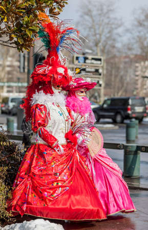 Annecy, France, February 24, 2013:  Portrait of a disguised couple posing in Annecy, France, during a Venetian Carnival which celebrates the beauty of the real Venice.のeditorial素材