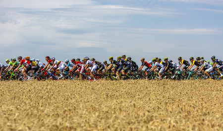 Vendeuvre-sur-Barse, France - July 6, 2017: The peloton passes through a region of wheat fields during the stage 6 of Tour de France 2017.のeditorial素材