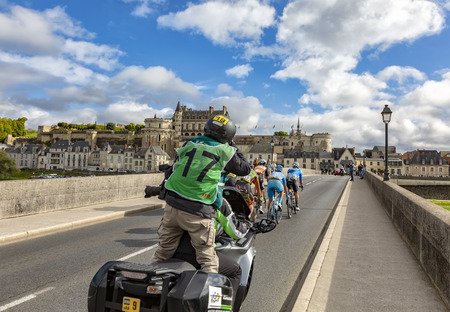 Amboise,France - October 8,2017: A photographer on a bike photographing the breakaway passing on the bridge in front of Amboise Castle during the Paris-Tours road cycling race.のeditorial素材