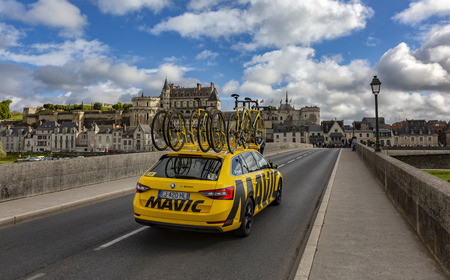 Amboise,France - October 8,2017: The yellow service car of Mavic driving on the bridge in front of Amboise Castle during the Paris-Tours road cycling race.のeditorial素材