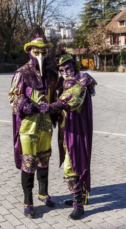 Annecy, France, March 16, 2014:  Portrait of a disguised couple, posing in Annecy, France, during a Venetian Carnival which celebrates the beauty of the real Venice.のeditorial素材