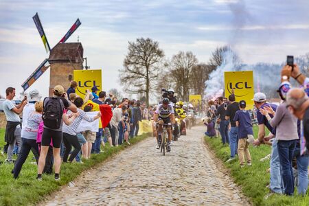 Templeuve, France - April 08, 2018: The triple road cycling world champion, Peter Sagan of Bora-Hansgrohe Team, leading the race on the cobblestone road in Templeuve in front of the traditional Vertain Windmill during Paris-Roubaix 2018. Sagan won this raのeditorial素材