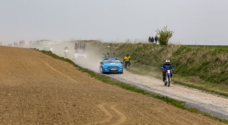Viesly, France - April 14, 2019: Image of a row of technical vehicles driving on the cobblestone road from Briastre to Viesly during Paris Roubaix 2019.のeditorial素材