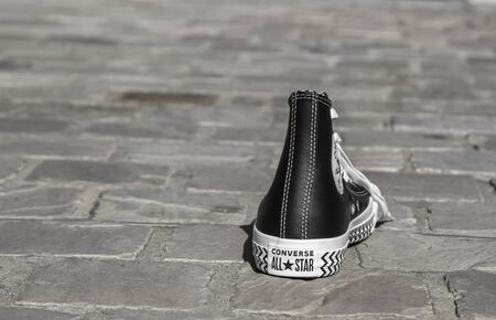 Chartres, France - Spetember 2, 2019: Image of an All Star Converse sneaker on a cobblestone street.のeditorial素材