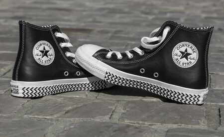 Chartres, France - Spetember 2, 2019: Image of a pair of All Star Converse sneakers on a cobblestone...