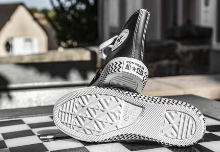 Chartres, France - Spetember 2, 2019: Image of a pair of All Star Converse sneakers on an urban...