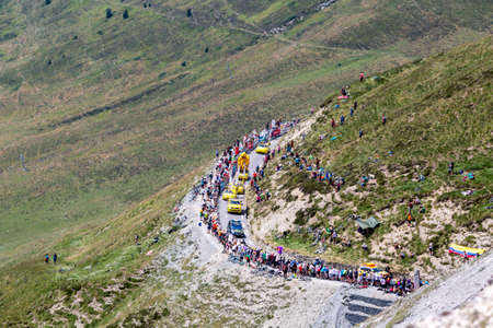 Col du Tourmalet, France - July 20, 2019: The Pubilicity Caravan passing before the cyclists on the road to Col du Tourmalet during the stage 14 of Tour de France 2019.のeditorial素材