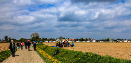 Camphin-en-PÃ©vÃ¨le, France - April 13, 2014: Image of cycling fans on a cobblestone road (Pave de la Justice) before the apparition of the cyclists during Paris-Roubaix 2014のeditorial素材