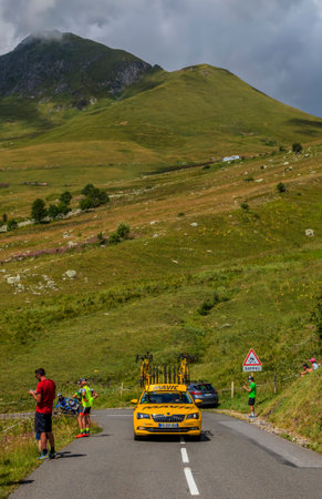 Col de la Madeleine, France - August 24, 2020: Yellow technical car of Mavic driving up on the road to Col de la Madeleine during the 3rd stage of Criterium du Dauphine 2020.のeditorial素材