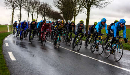 Angerville, France - March 6, 2017: The peloton riding on a wet road during the second stage of...