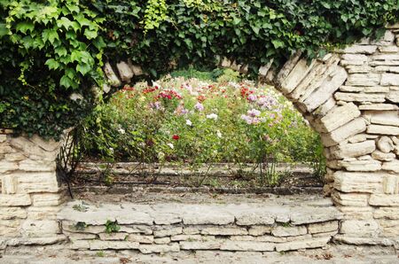 Photo of the Natural Stone Wall With Greeneryの写真素材