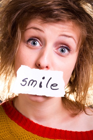 A close-up portrait of a beautiful girl having a smile on her face の写真素材