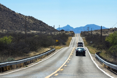 Cars driving on desert highway in Arizonaの写真素材