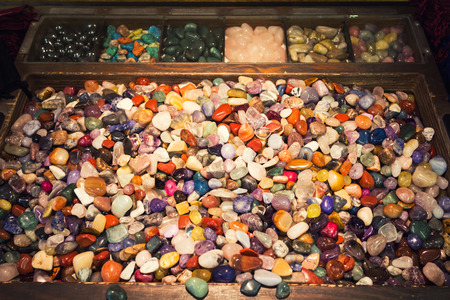 The energy of a box full of colorful mixed gemstonesの写真素材