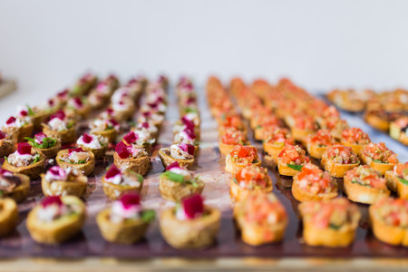 Selection of delicious canapes placed on a trayの写真素材