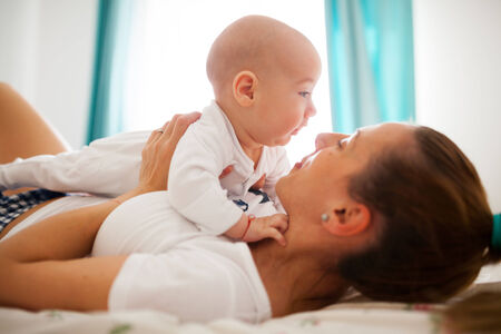 Young mother is hugging baby boy