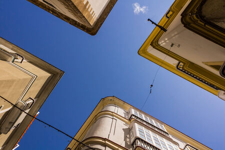 Four buildings shot from below with sky above. Capture taken in Cadiz, Spain.の写真素材