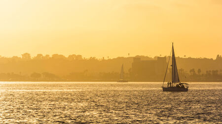 A boat sailing at sunset.の写真素材
