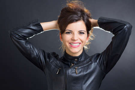 Image of a brunette rocker smiling perfectlyの写真素材