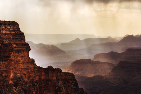 Fog over the magnificent silhouettes of the Grand Canyonの写真素材