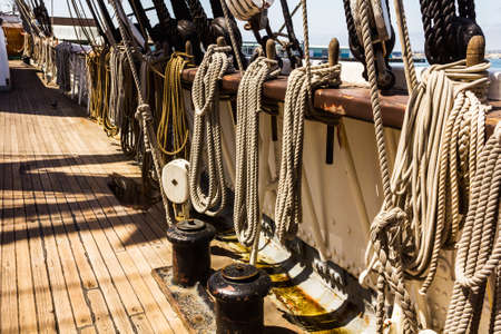 A closeup of ropes hanged on a ship's deckの写真素材