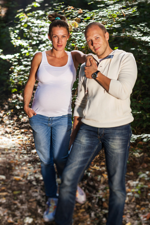 A husband and his pregnant wife holding handsの写真素材